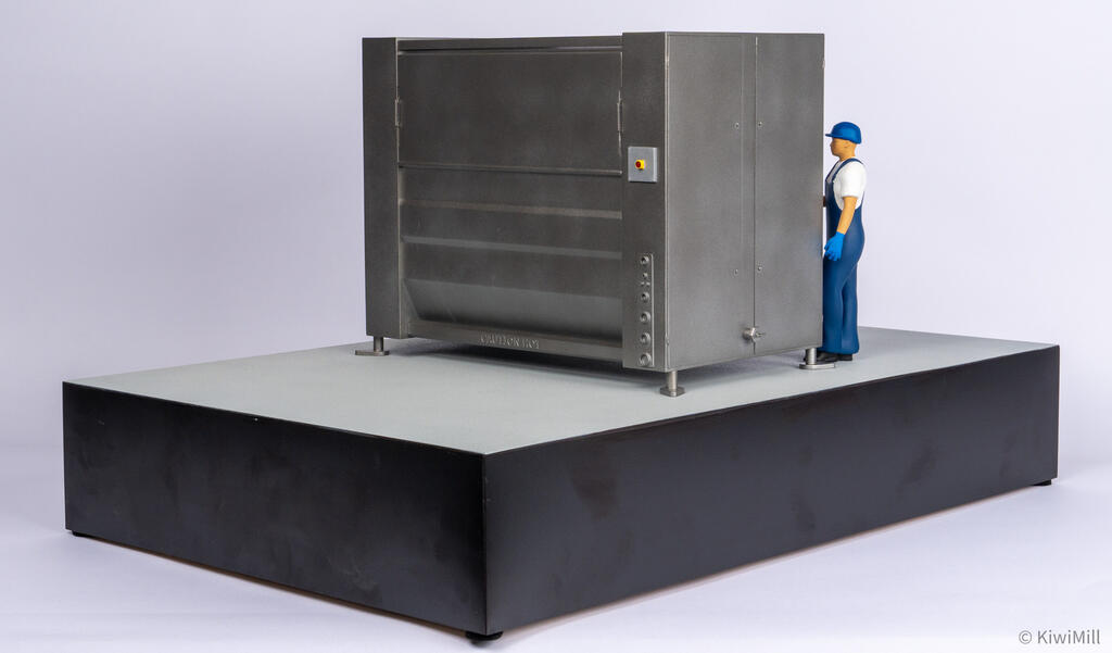 Low right rear angle of the chiller model showing back panels, connection ports, and operator figure at the end doors